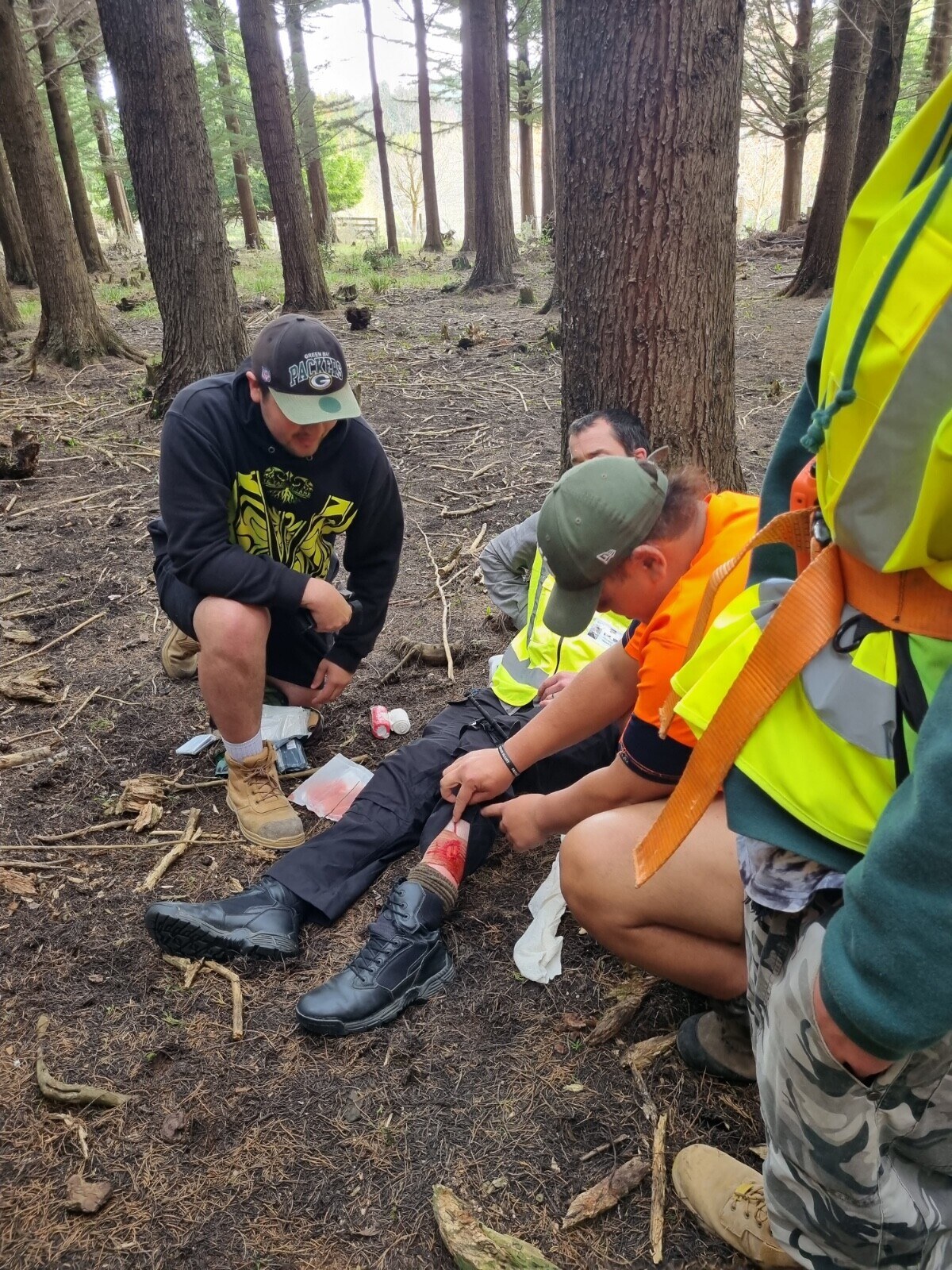 Manaia Olsen (left) and Kaloni Taylor (right) taking lead in assisting Scott Carr with cut artery scenario training.
